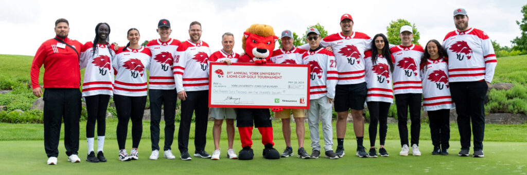 Representatives from York U Athletics stand with a large, ceremonial cheque.